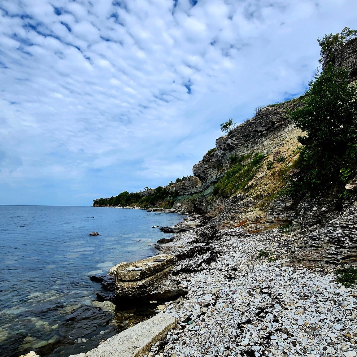 Rocky coastal cliffs beside calm blue water