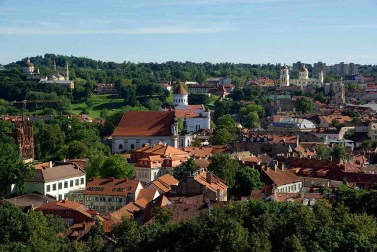 Aerial view of Vilnius with historic buildings and greenery.