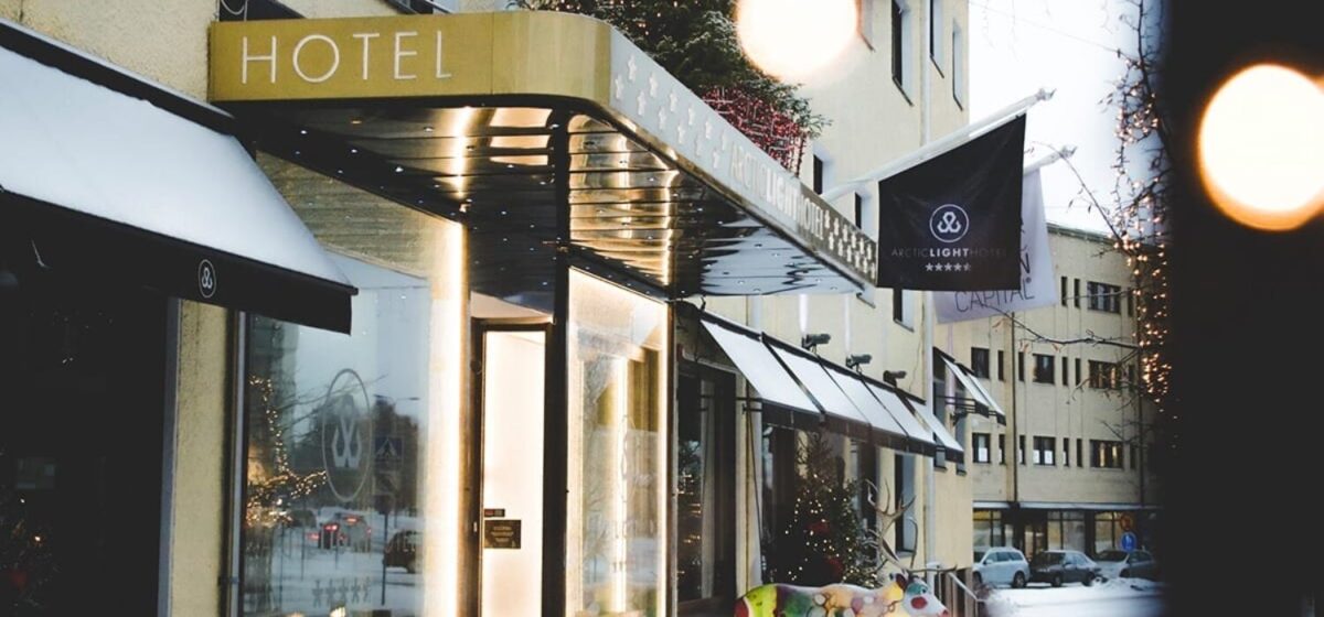Exterior of a lit hotel entrance in winter