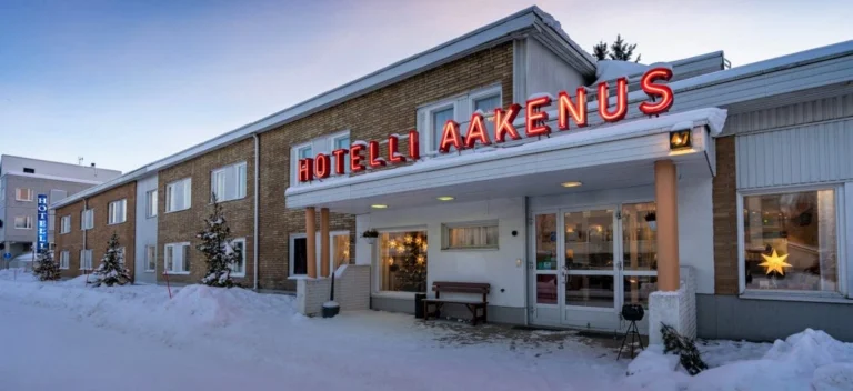 Exterior view of a snowy hotel entrance.