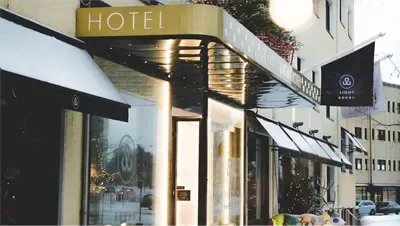 Modern hotel entrance with illuminated canopy and signage