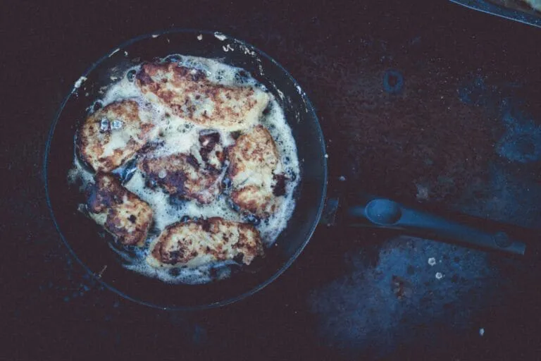 Chicken pieces frying in pan with butter
