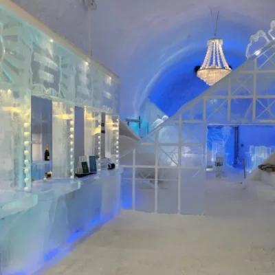 Ice hotel bar with chandelier and blue lighting