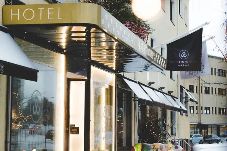 Hotel entrance with illuminated awning on snowy street