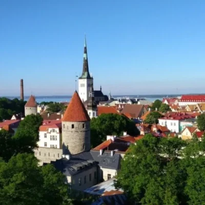 Historic cityscape with red roofs and church spire