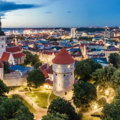 Medieval tower overlooking illuminated city at dusk