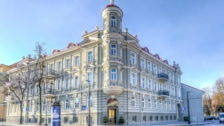 Ornate historic corner building with tower and balconies