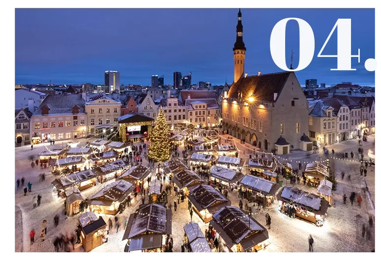 Tallinn Christmas market at dusk in snowy Town Hall Square